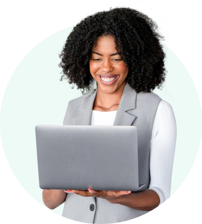 An administrator smiling at an open laptop