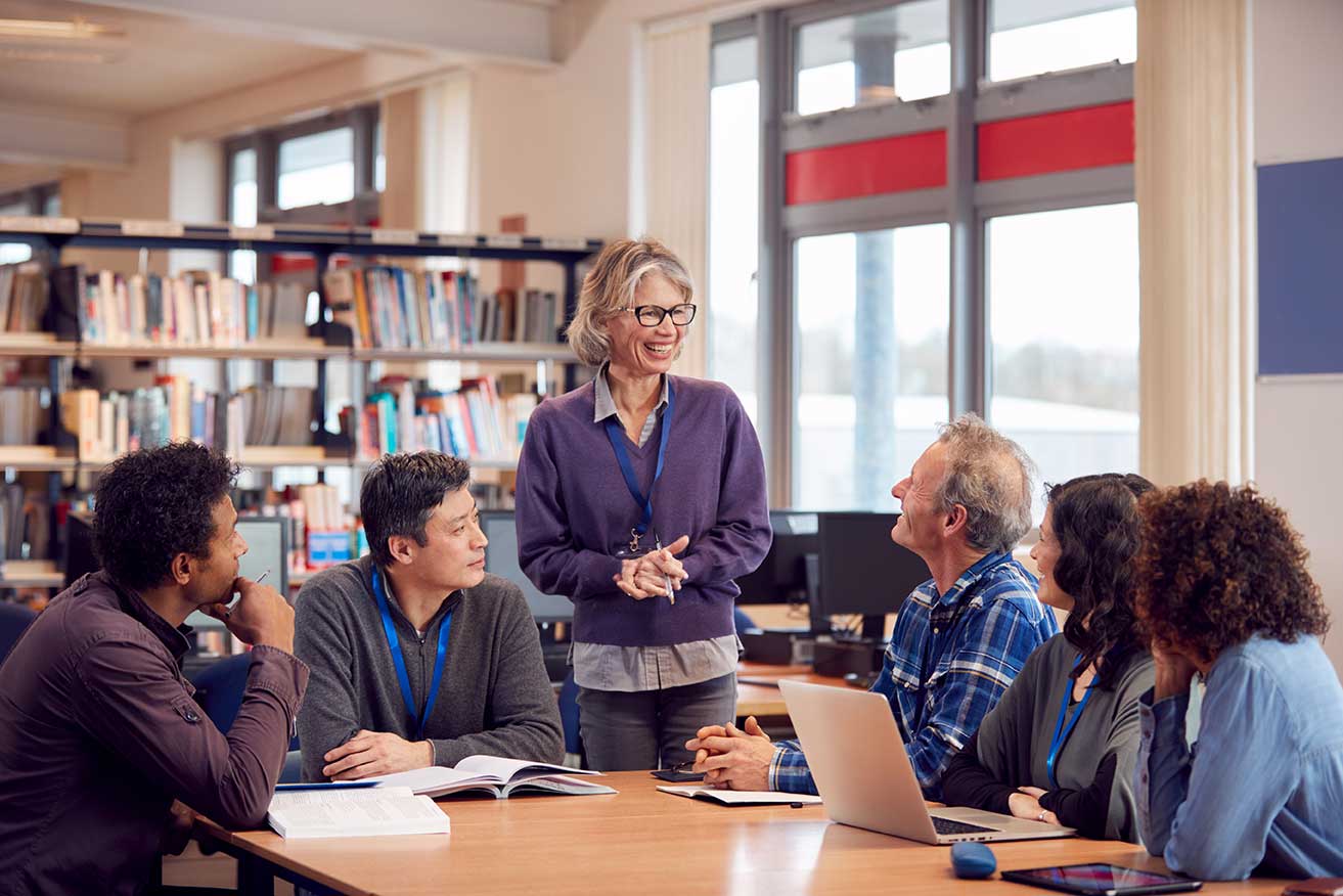 Administrator having a meeting with teachers.