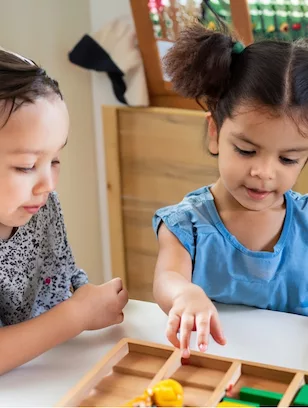 two children play learning at a montessori school