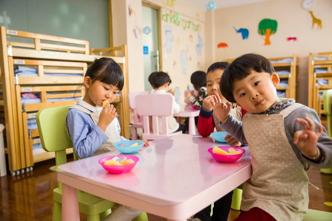 Toddlers eating on a table